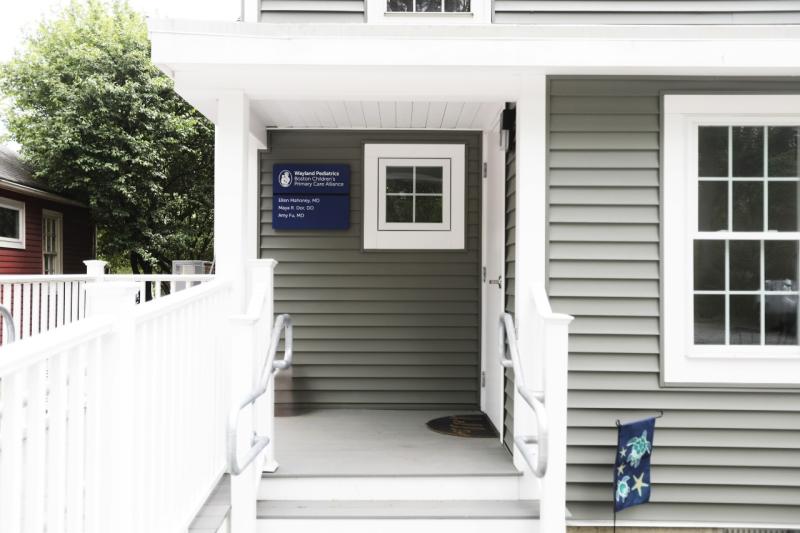the entrance to a house with a sign that says wayland pediatrics